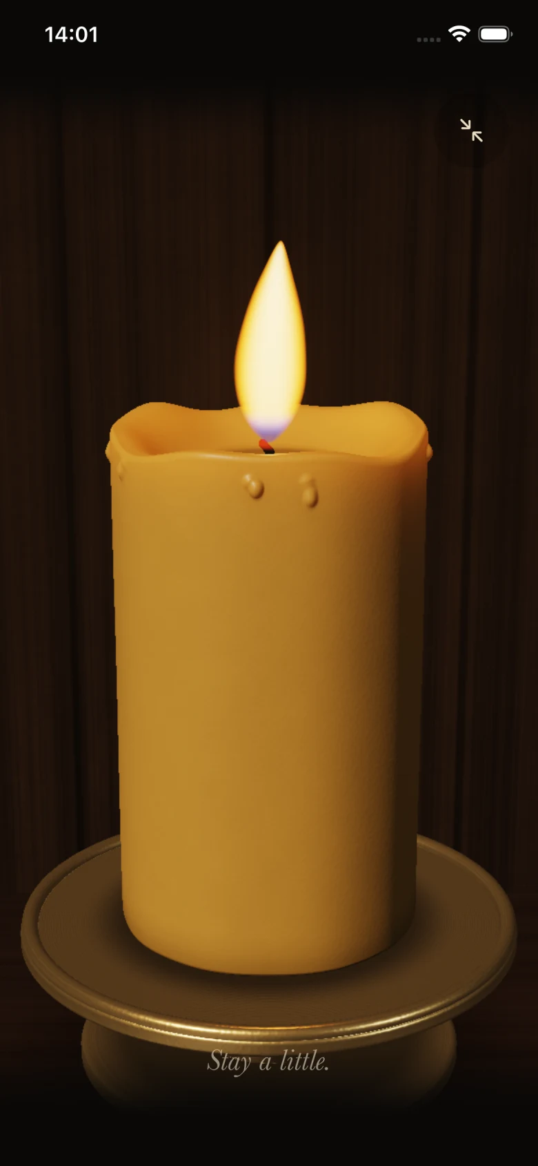 A golden honey candle in a brass holder, against a walnut wood background